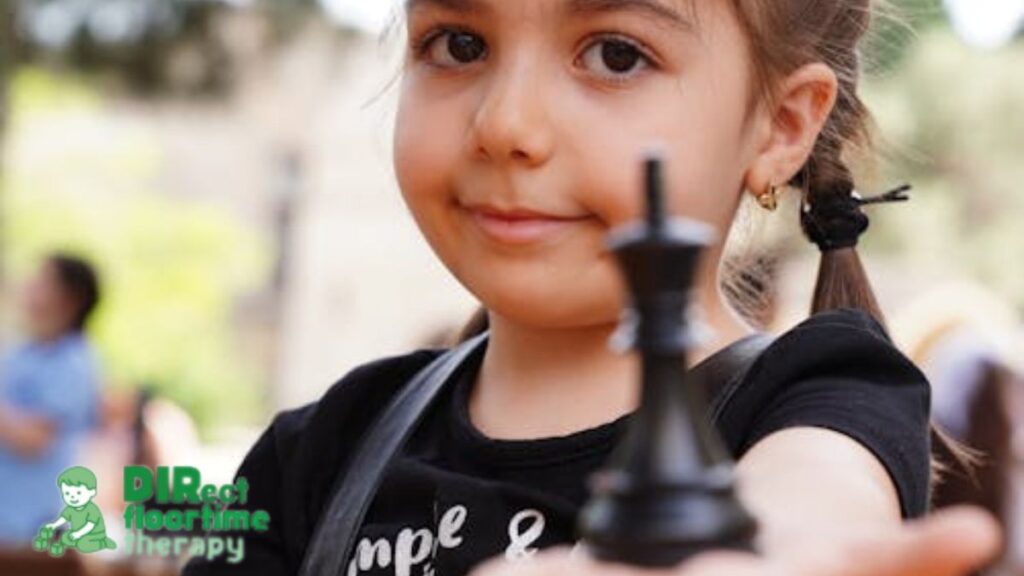 Social skills counseling session where a young girl holds out a chess piece to the camera, symbolizing friendship and reaching out.