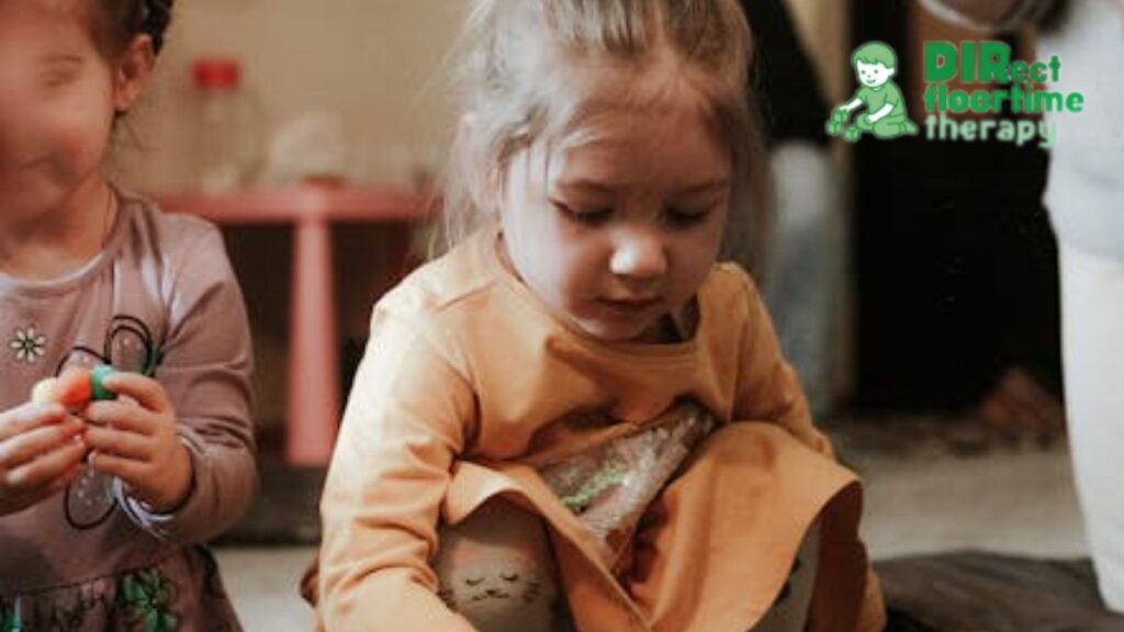 Social skills counseling session where a young girl feels comfortable in a classroom play setting, participating and focused on her own task.