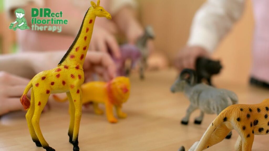 A menagerie of plastic toys lined up in a play therapy NJ room, creating a playful and inviting space for children.