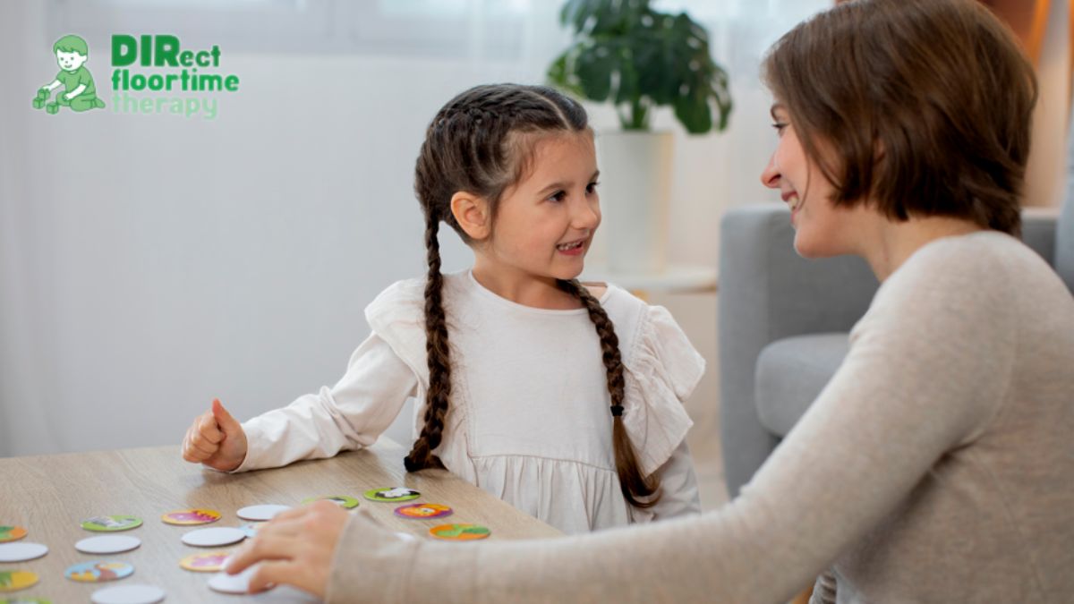 Female therapist engaging with a young girl in a behavioral therapy session; the child looks happy, content, and enjoying the activity.