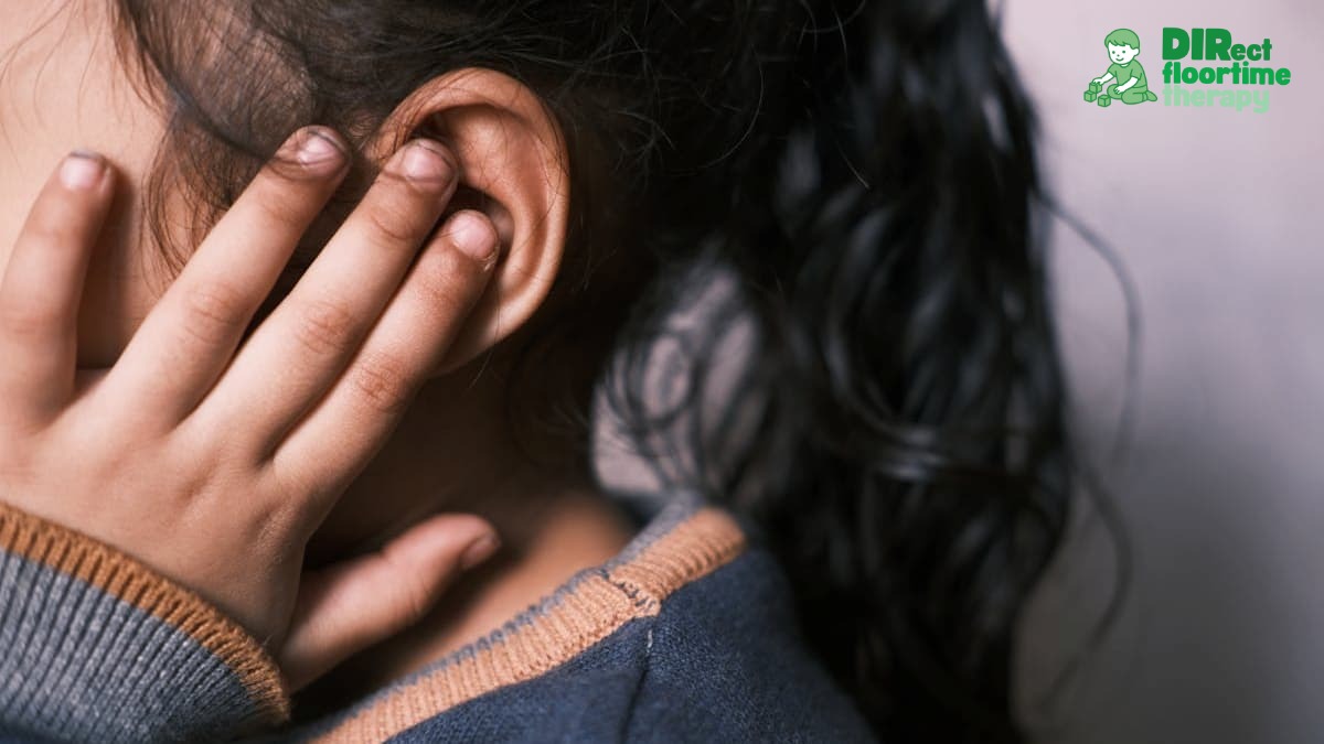 A girl covering her ears