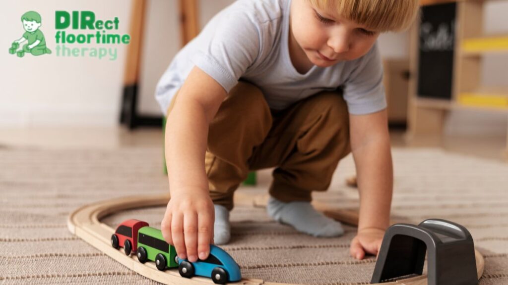 A young boy sits on the floor playing with toy trains, practicing executive functioning skills.
