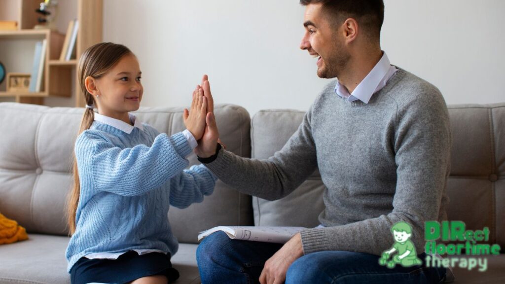 A father engages his child in a calming activity while sitting together on the sofa.