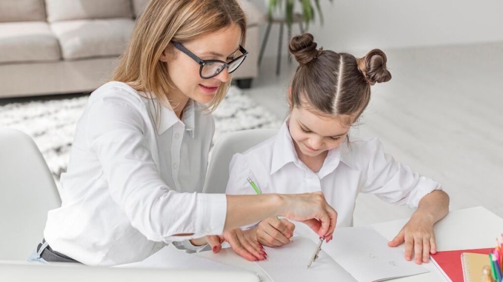 A therapist closely guides a young girl through activities in a therapy room.