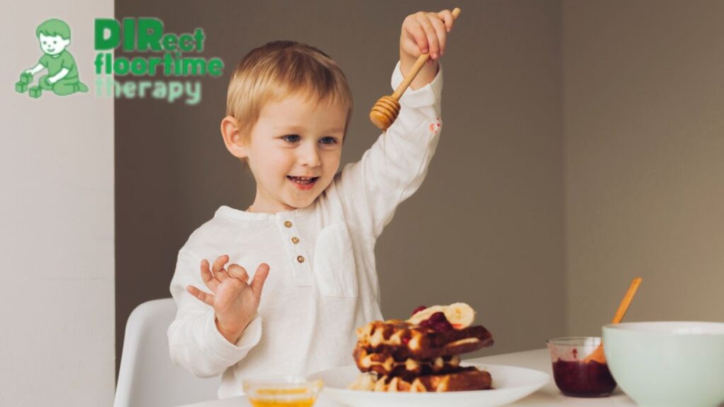 Picky eater autism, a young boy fascinatedly watching syrup drizzle over his breakfast waffles.