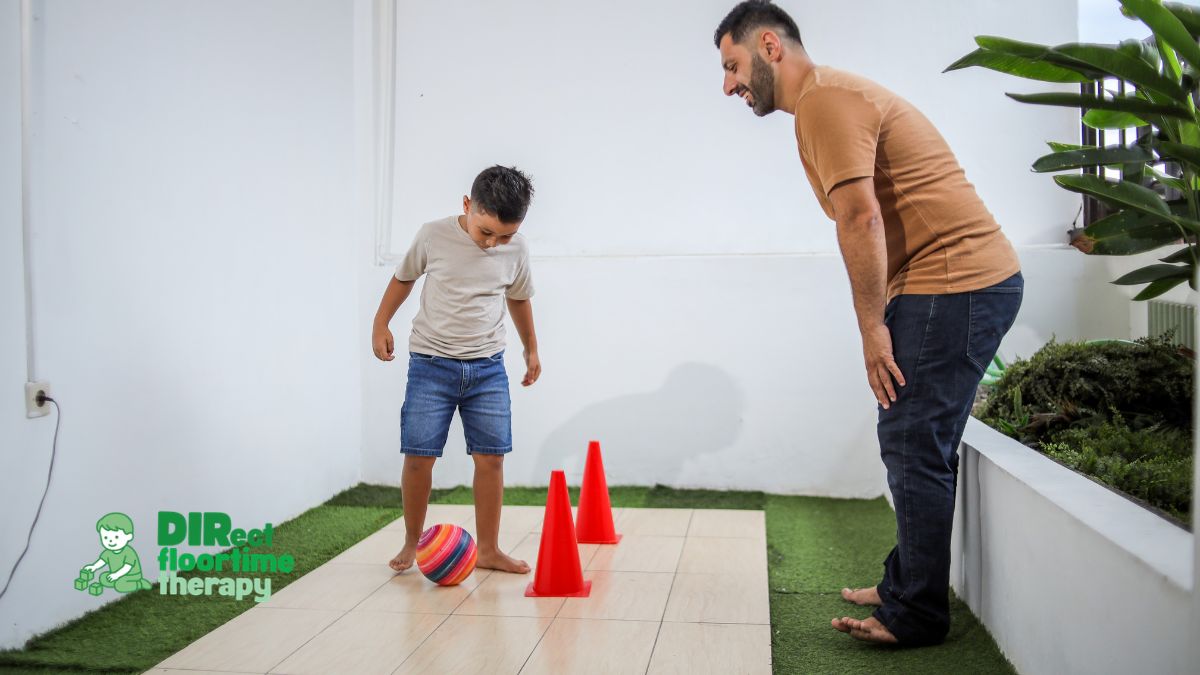 Father coaching child through obstacle course and ball activity during DIRFloortime therapy session to support motor skills, communication, and emotional regulation at home in New Jersey.
