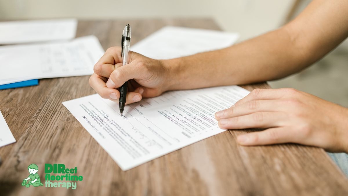 Parent completing autism evaluation paperwork before a DIRFloortime therapy assessment at Direct Floortime Therapy in New Jersey.