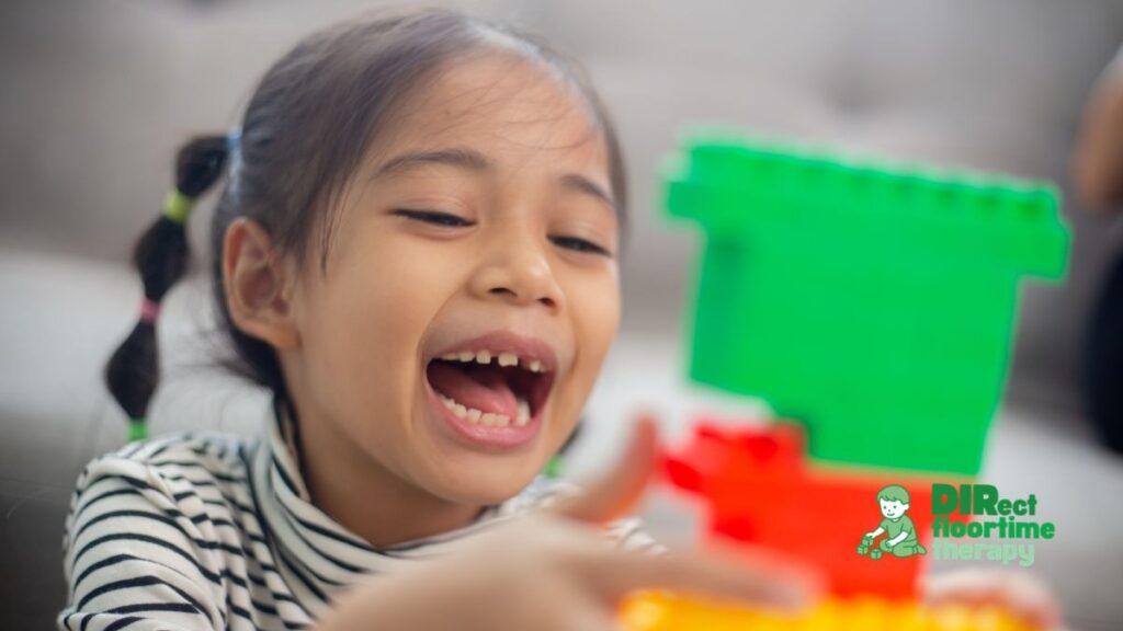 A child engaged in play, mouth open as if speaking or repeating a phrase, expression showing genuine engagement and communication intent: 'autistic child speaking play communicative intent engaged expression-"Echolalia "